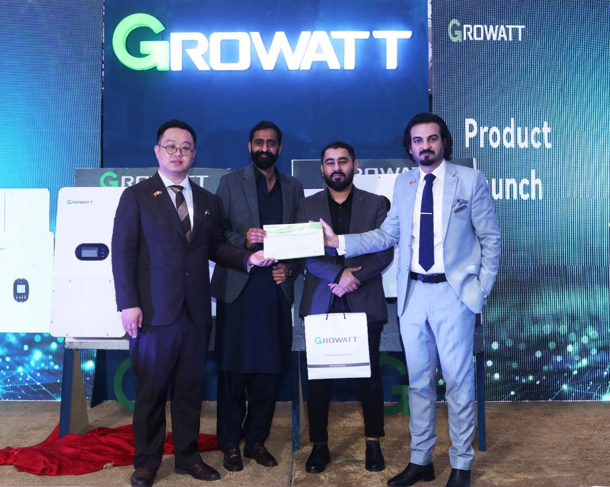 From Roadshow to Expo: Growatt Champions Sustainable Energy Innovation in Pakistan, Four men are standing in front of a Growatt backdrop, holding a certificate at a product launch event, with