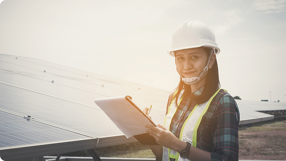 Growatt Gender equality, a female engineer with clipboard beside solar panels.