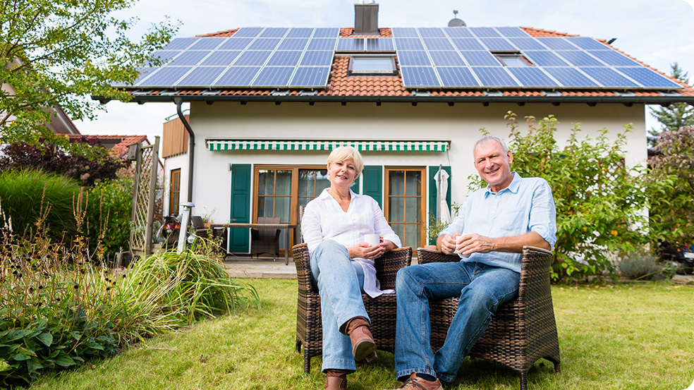 growatt social responsibility, growatt csr, Two people sitting in a garden with a house with solar panels in the background